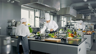 chefs working in a commercial kitchen under air conditioning